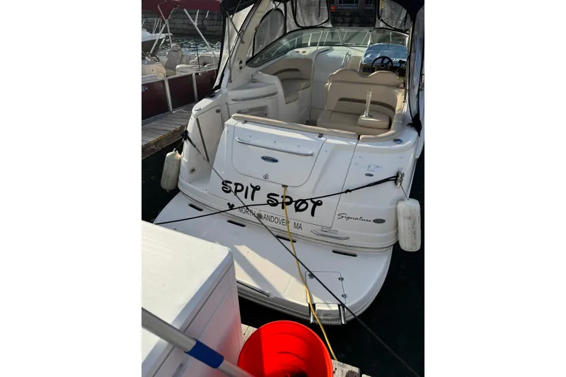 Slide: The Image of 2006 Chaparral 290 Signature boat docked, featuring spacious seating and protective canopy. - 7
