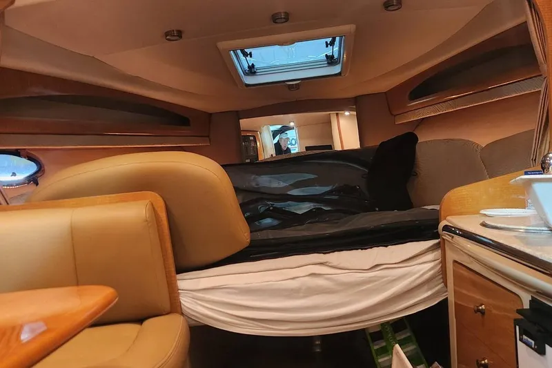 Slide: The Image of Interior of 2006 Chaparral 290 Signature boat, featuring cozy seating and a compact cabin layout. - 8