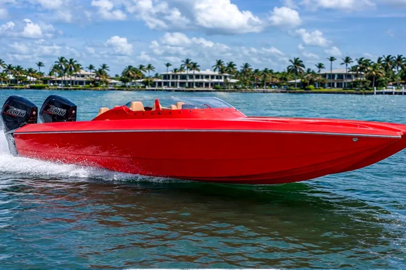 The Image of Red 2025 Bravo Powerboats XP 30 speeding on water with palm trees in background. - 0