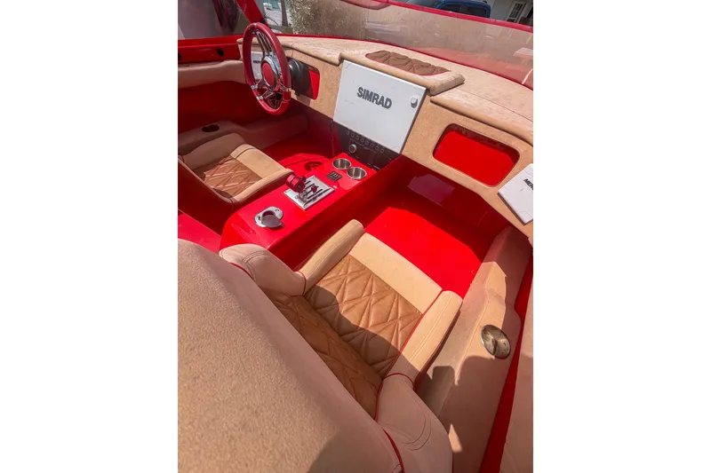 Slide: The Image of Interior of 2025 Bravo Powerboats XP 30, featuring red and beige seating with Simrad navigation. - 4