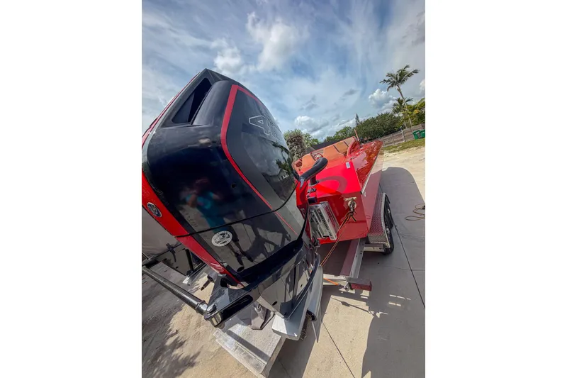 Slide: The Image of 2025 Bravo Powerboats XP 30 with powerful outboard engine on trailer, under a clear sky. - 6