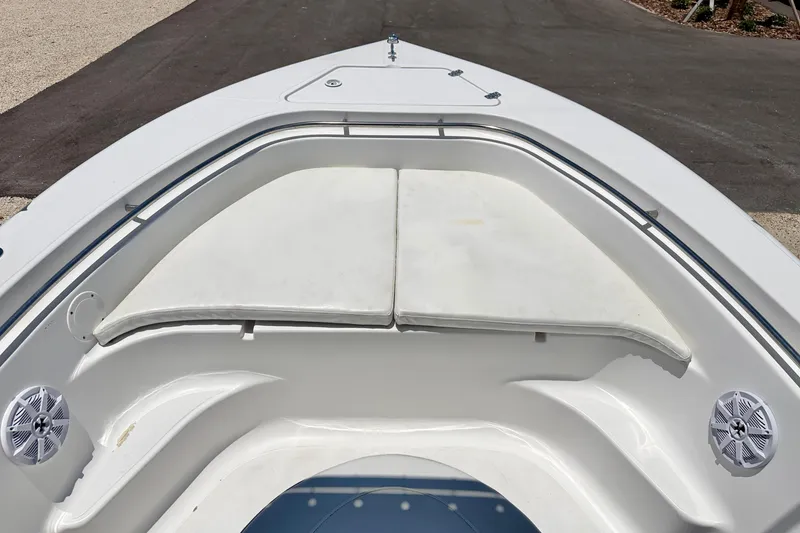 Slide: The Image of Bow seating area of a 2009 Sea Fox 216 Center Console boat with white cushions. - 11
