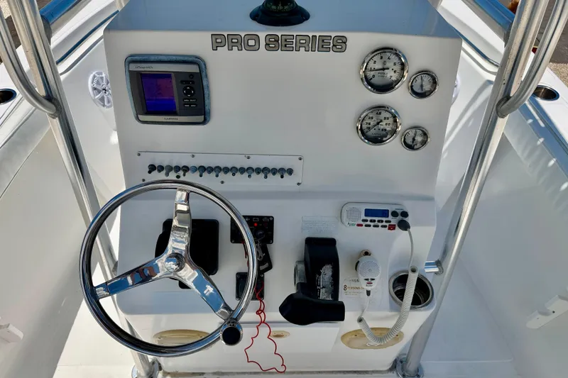 Slide: The Image of Center console of 2009 Sea Fox 216, featuring steering wheel and navigation instruments. - 16