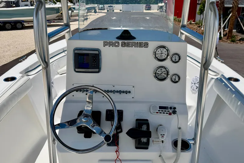 Slide: The Image of 2009 Sea Fox 216 Center Console boat dashboard with steering wheel and gauges. - 17
