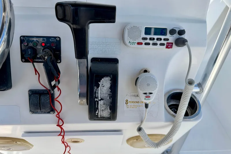 Slide: The Image of Control panel of a 2009 Sea Fox 216 Center Console boat with radio and throttle. - 21