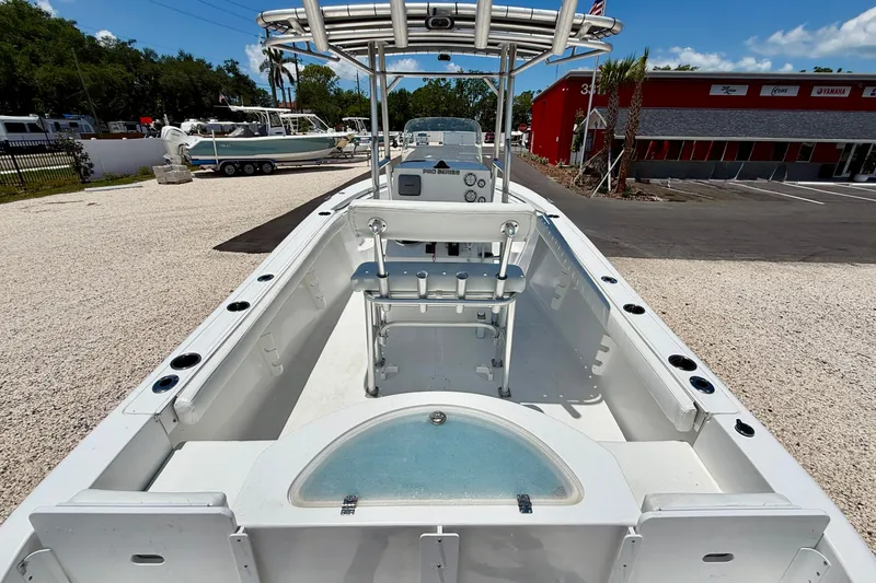Slide: The Image of 2009 Sea Fox 216 Center Console boat with T-top, docked outdoors under clear skies. - 24