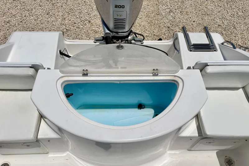 Slide: The Image of 2009 Sea Fox 216 Center Console boat with open livewell and outboard motor. - 26