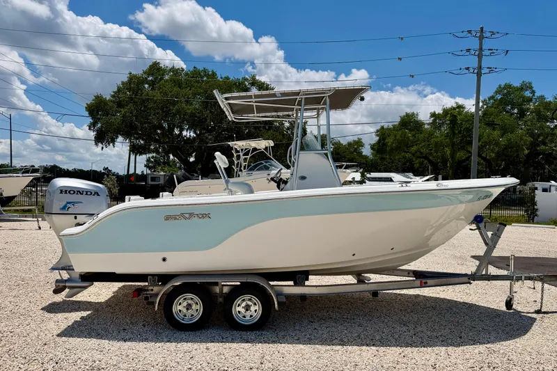 Slide: The Image of 2009 Sea Fox 216 Center Console boat on trailer, featuring Honda outboard motor. - 4