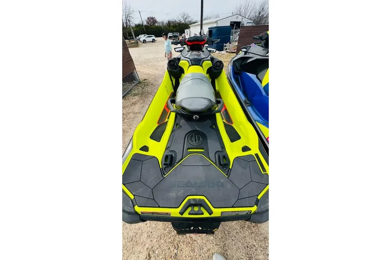 Slide: The Image of 2020 Sea-Doo RXT-X 300 jet ski in vibrant yellow, parked outdoors. - 3