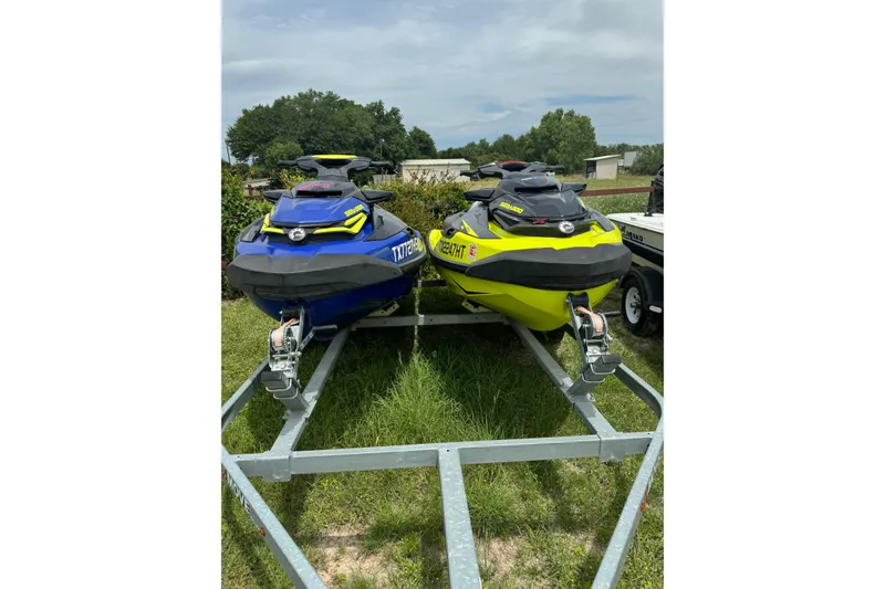 Slide: The Image of 2020 Sea-Doo RXT-X 300 jet skis in blue and yellow on a trailer. - 4