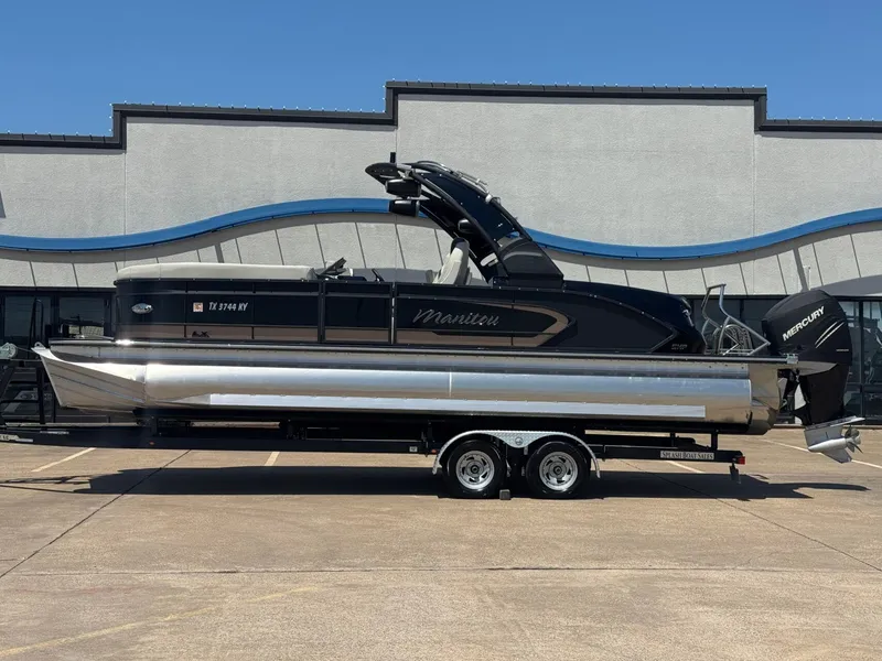 The Image of 2024 Manitou 25 LX RFX SHP pontoon boat on trailer. - 1