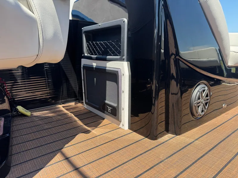 Slide: The Image of Interior of 2024 Manitou 25 LX RFX SHP with speaker and seating. - 13