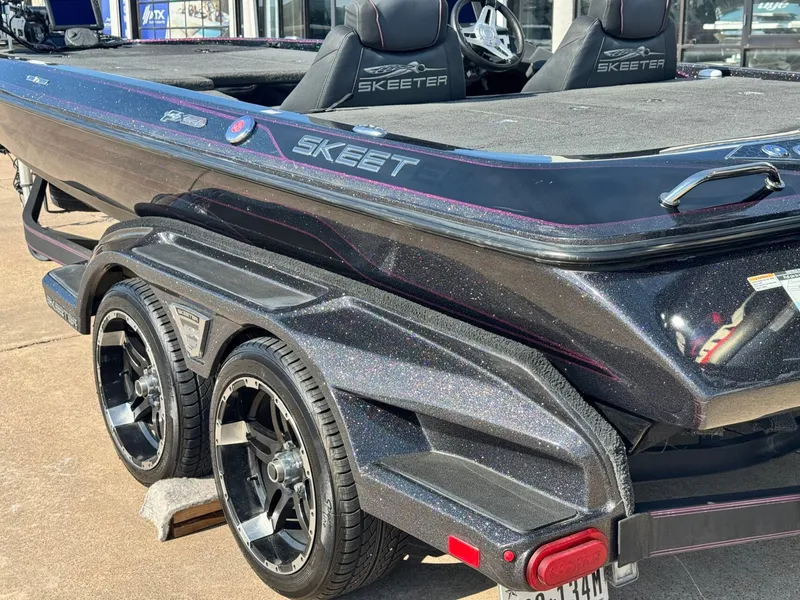 Slide: The Image of 2018 Skeeter FX21 boat with shiny trailer and dual seats. - 7