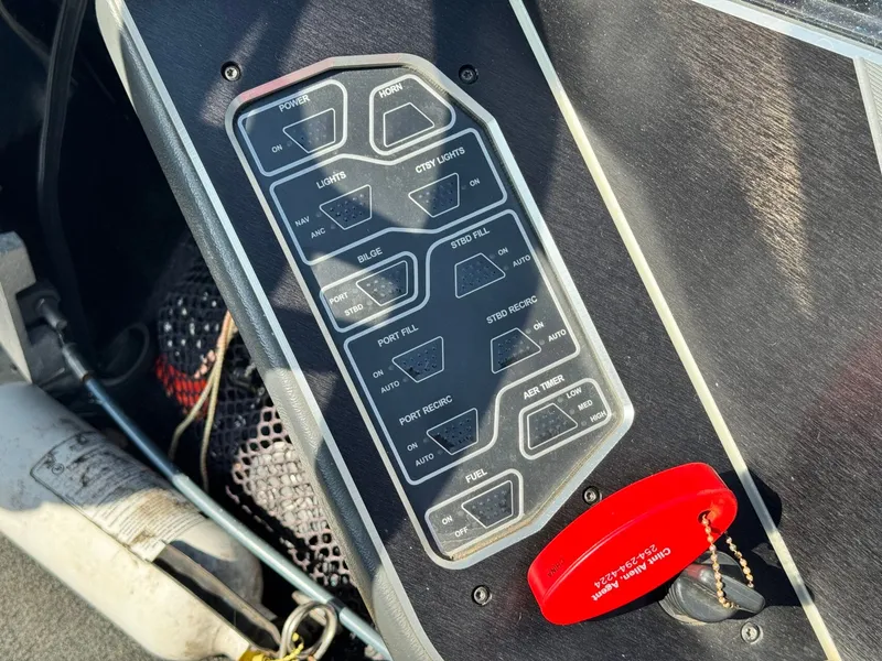 Slide: The Image of Control panel of a 2018 Skeeter FX21 boat with switches and red safety key. - 9