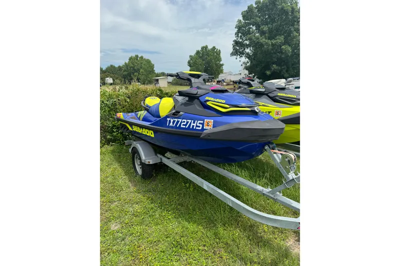 Slide: The Image of 2019 Sea-Doo Wake Pro 230 jet ski on trailer, parked on grass. - 1