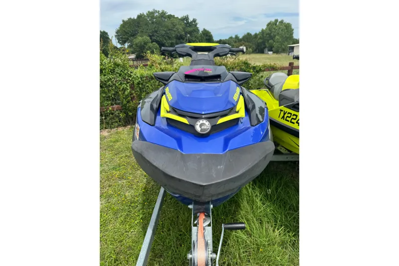 Slide: The Image of 2019 Sea-Doo Wake Pro 230 jet ski in vibrant blue, parked on grass. - 3