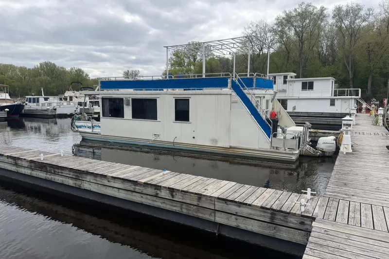 The Image of 1997 Catamaran Cruisers 44' Aqua Cruiser docked at marina, surrounded by trees. - 1