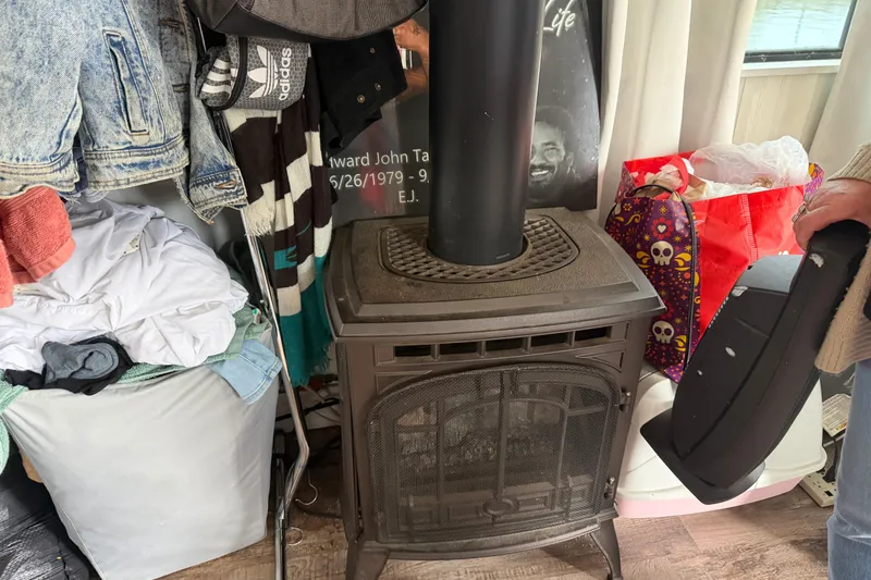 Slide: The Image of Cozy interior of 1997 Catamaran Cruisers Aqua Cruiser with stove and assorted items. - 11