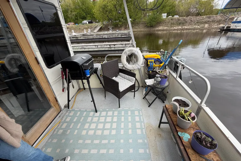 Slide: The Image of Outdoor deck of a 1997 Catamaran Cruisers 44' Aqua Cruiser with seating and plants. - 13