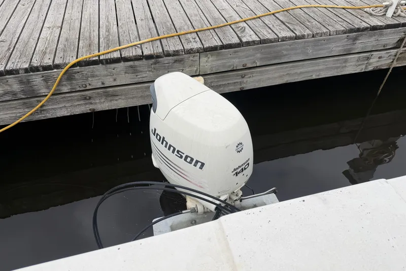 Slide: The Image of Outboard motor by Johnson on a 1997 Catamaran Cruisers 44' Aqua Cruiser at dock. - 14