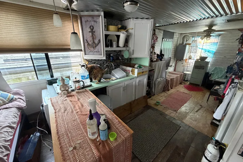 Slide: The Image of Interior of a 1997 Catamaran Cruisers 44' Aqua Cruiser with cozy decor and kitchen area. - 5