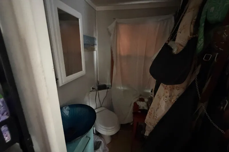 Slide: The Image of Small bathroom inside a 1997 Catamaran Cruisers 44' Aqua Cruiser, featuring a toilet and mirror. - 8