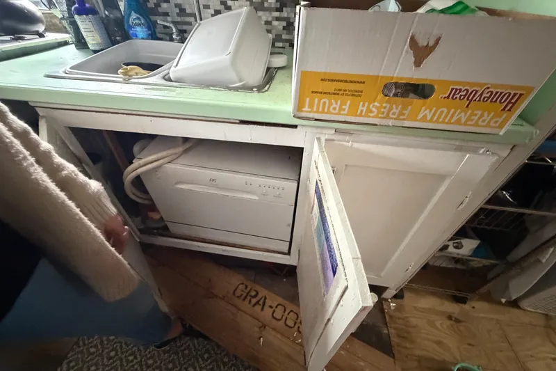 Slide: The Image of Kitchen area of a 1997 Catamaran Cruisers 44' Aqua Cruiser with dishwasher and sink. - 9