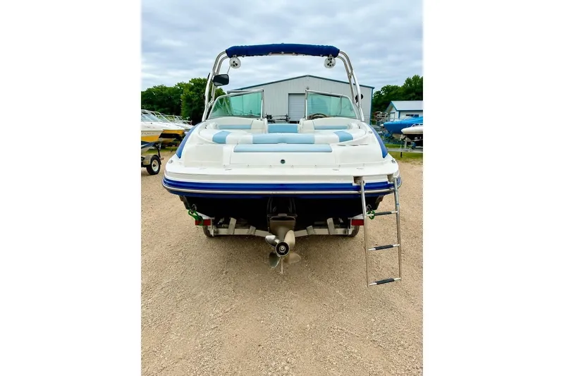 Slide: The Image of 2007 Rinker 226 Captiva Bowrider with ladder, parked outdoors, showcasing rear view. - 3