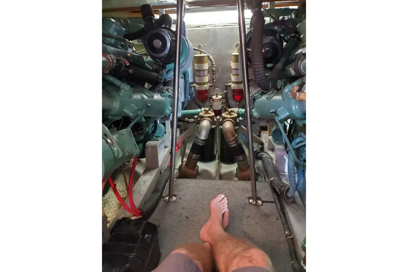 Slide: The Image of Engine room of a 1978 Bertram 46.6 yacht, showing dual engines and mechanical components. - 10