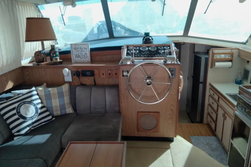 Slide: The Image of Interior of a 1978 Bertram 46.6 yacht with helm, seating, and kitchen area. - 11