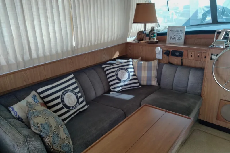 Slide: The Image of Interior of a 1978 Bertram 46.6 yacht with cozy seating and nautical decor. - 12