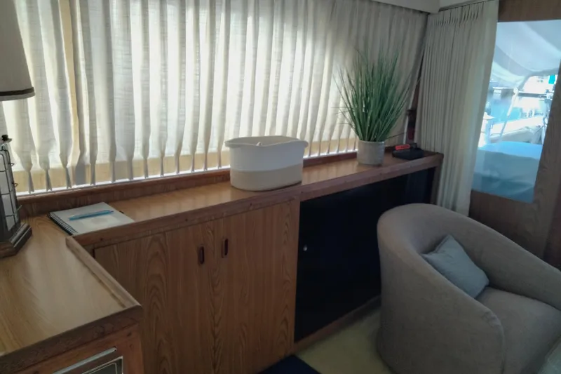 Slide: The Image of Interior of a 1978 Bertram 46.6 yacht with wooden cabinetry and cozy seating. - 13