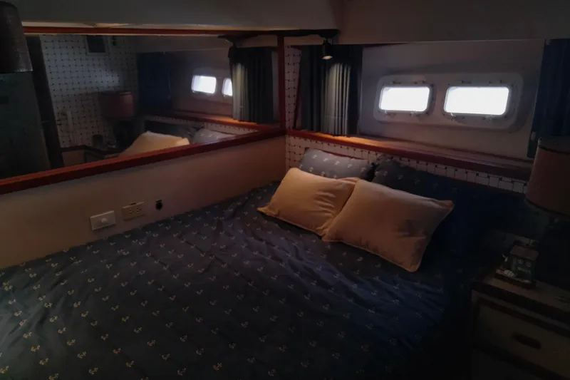 Slide: The Image of Cozy bedroom interior of a 1978 Bertram 46.6 yacht with nautical decor. - 16