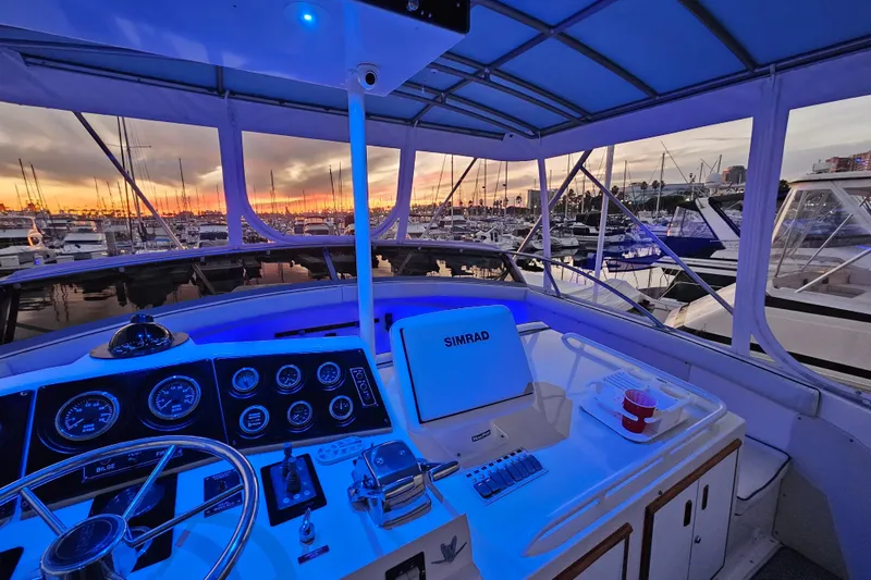 Slide: The Image of Cockpit view of 1978 Bertram 46.6 yacht at sunset in marina. - 5