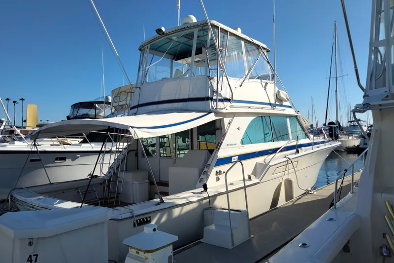Slide: The Image of 1978 Bertram 46.6 yacht docked at marina under clear blue sky. - 8