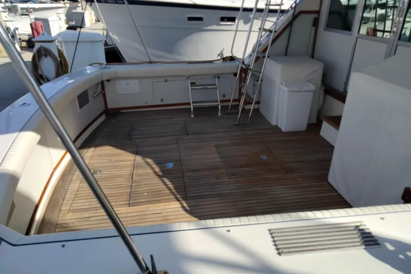 Slide: The Image of Spacious deck of a 1978 Bertram 46.6 yacht with wooden flooring and seating. - 9