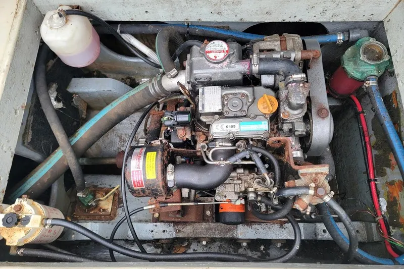 Slide: The Image of Engine compartment of a 1974 Marshall 22 Catboat, showing detailed mechanical components. - 14