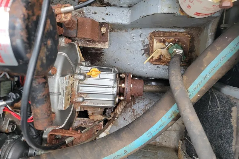 Slide: The Image of Engine compartment of a 1974 Marshall 22 Catboat, showing mechanical components and hoses. - 16