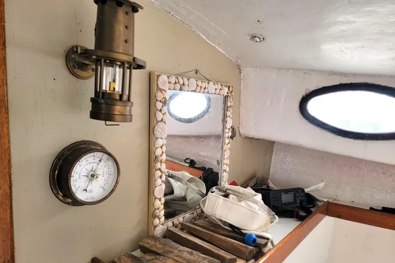 Slide: The Image of Interior of a 1974 Marshall 22 Catboat with nautical decor and vintage barometer. - 2
