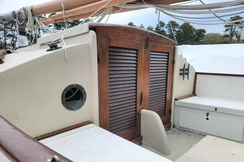 Slide: The Image of 1974 Marshall 22 Catboat cockpit with wooden hatch and rigging. - 20