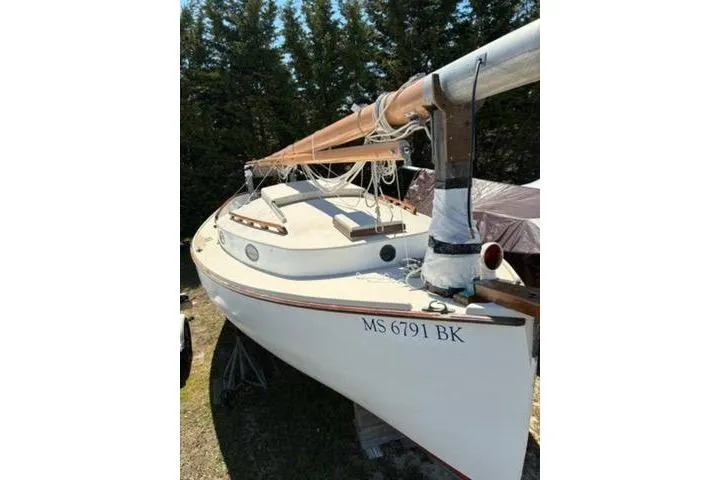 Slide: The Image of 1974 Marshall 22 Catboat with wooden mast, docked outdoors, registration MS 6791 BK. - 29