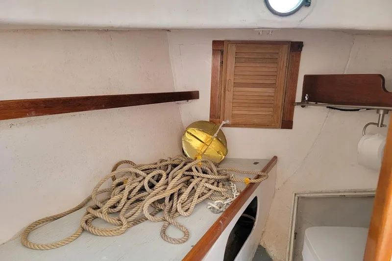 Slide: The Image of Interior of a 1974 Marshall 22 Catboat with ropes and nautical equipment. - 5