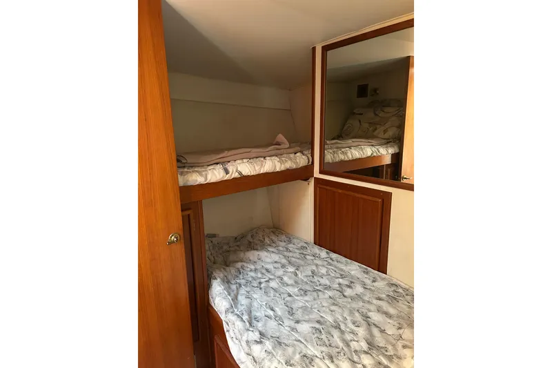 Slide: The Image of Interior of 1990 Post 46 Convertible yacht with cozy bunk beds and wooden cabinetry. - 14