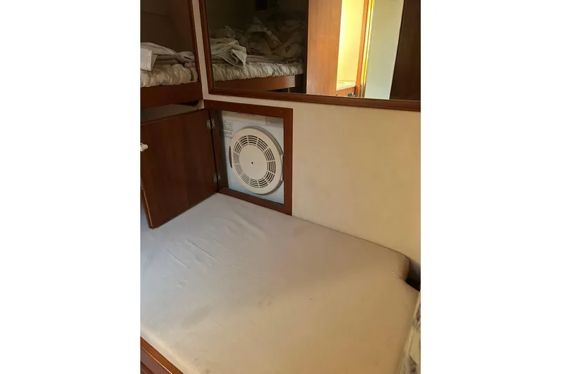 Slide: The Image of Interior cabin of a 1990 Post 46 Convertible yacht with a fan and bedding. - 15