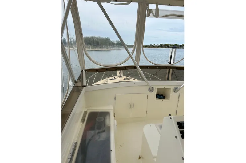 Slide: The Image of Interior view of a 1990 Post 46 Convertible boat with water and shoreline visible. - 18