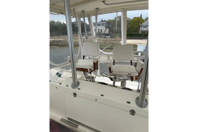 Slide: The Image of Interior view of a 1990 Post 46 Convertible yacht with two white captain's chairs. - 19