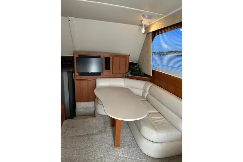 Slide: The Image of Luxurious interior of 1990 Post 46 Convertible yacht with leather seating and TV. - 2