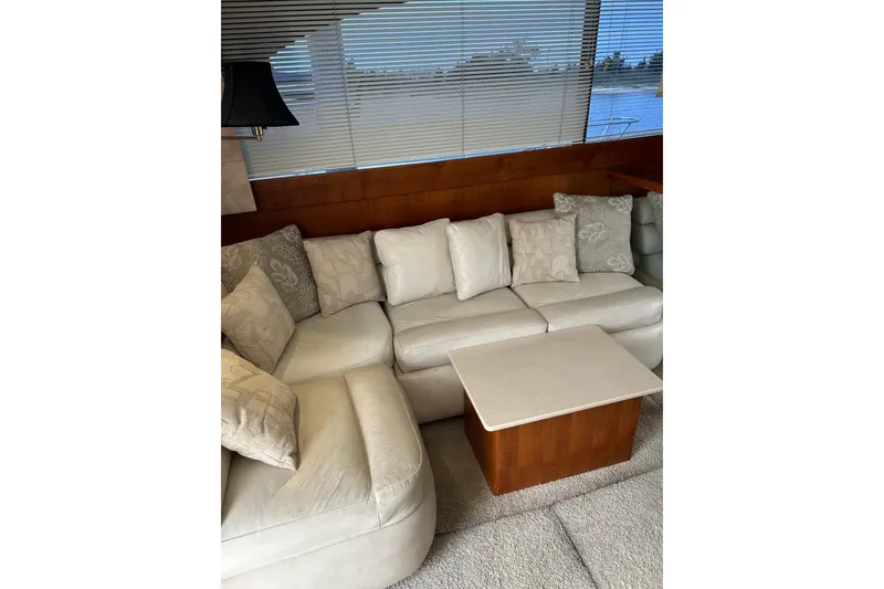 Slide: The Image of Luxurious interior of 1990 Post 46 Convertible yacht with plush white seating and wooden accents. - 3