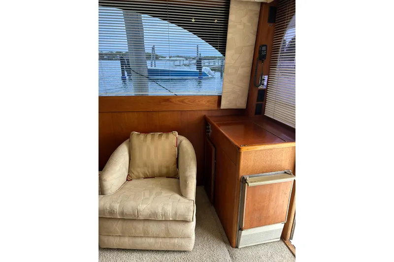 Slide: The Image of Interior of a 1990 Post 46 Convertible yacht with chair and wooden cabinetry. - 5
