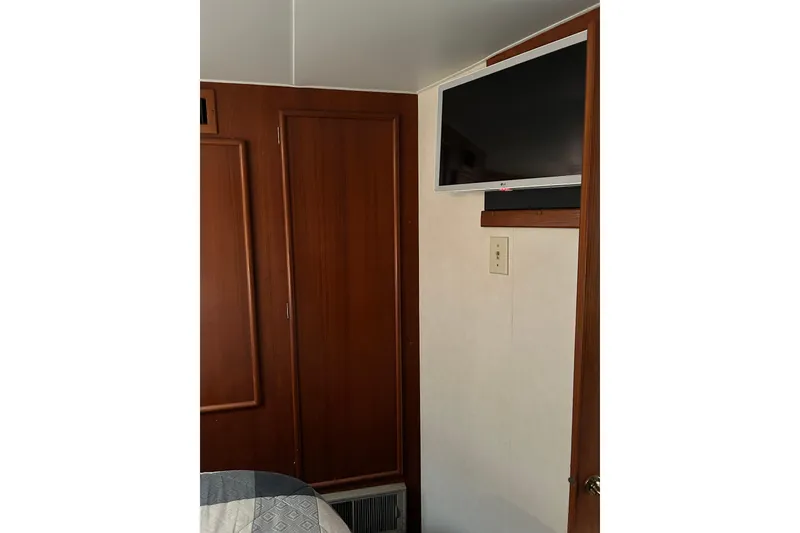 Slide: The Image of Interior of 1990 Post 46 Convertible with mounted TV and wooden cabinetry. - 9